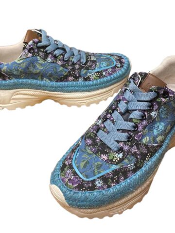 a pair of floral blue and purple Coach sneakers.