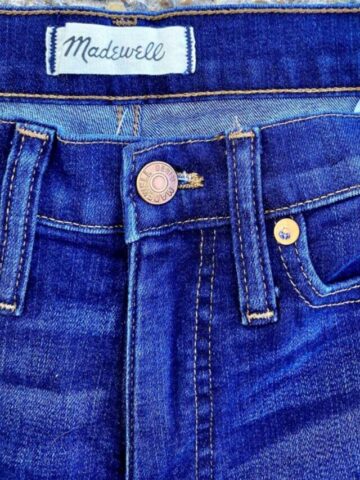 close up of a pair of madewell jeans showing the brand tag and style.