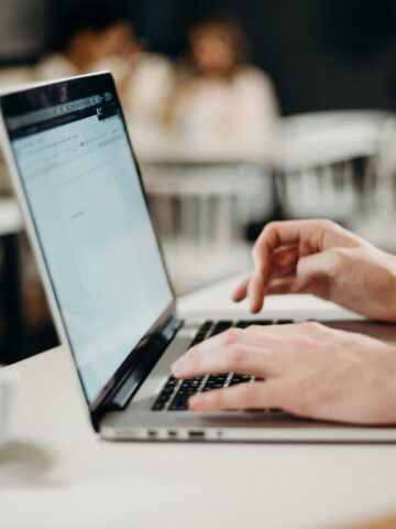 person typing on a laptop.