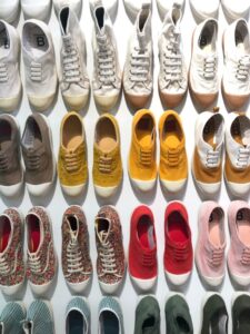 multiple pairs of sneakers lined up next to each other.