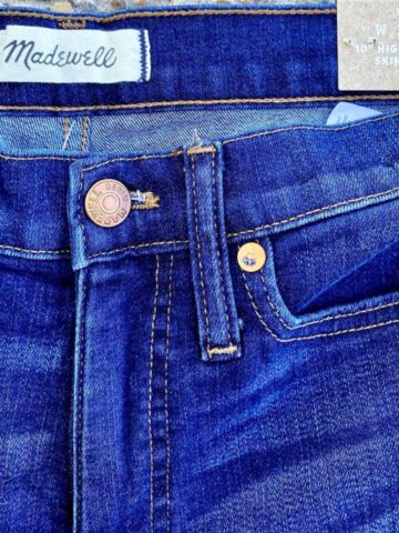 close up of a pair of madewell jeans showing the brand tag and style.