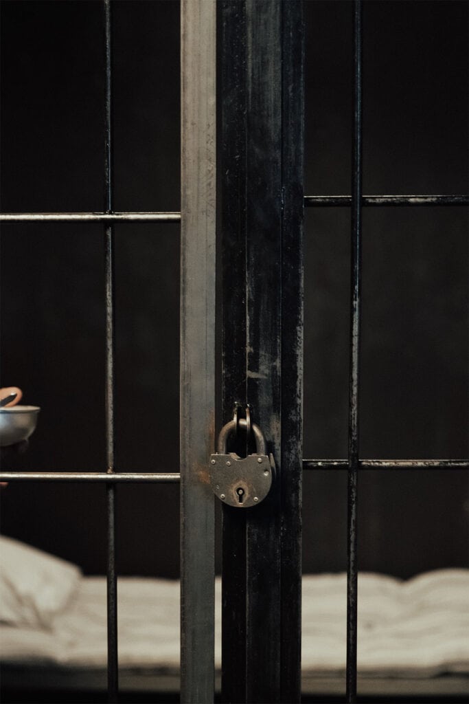 a lock on the outside of a jail cell.