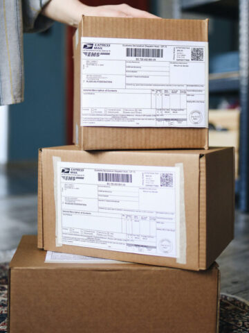 stacks of three boxes with shipping labels attached ready for delivery.