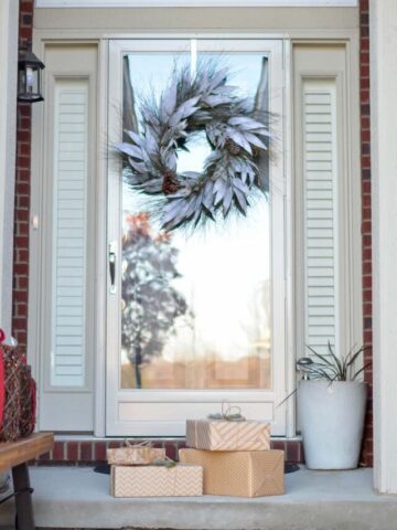 4 wrapped packages sitting on a porch.