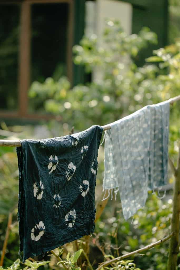 dyed fabric hanging out on a rope.