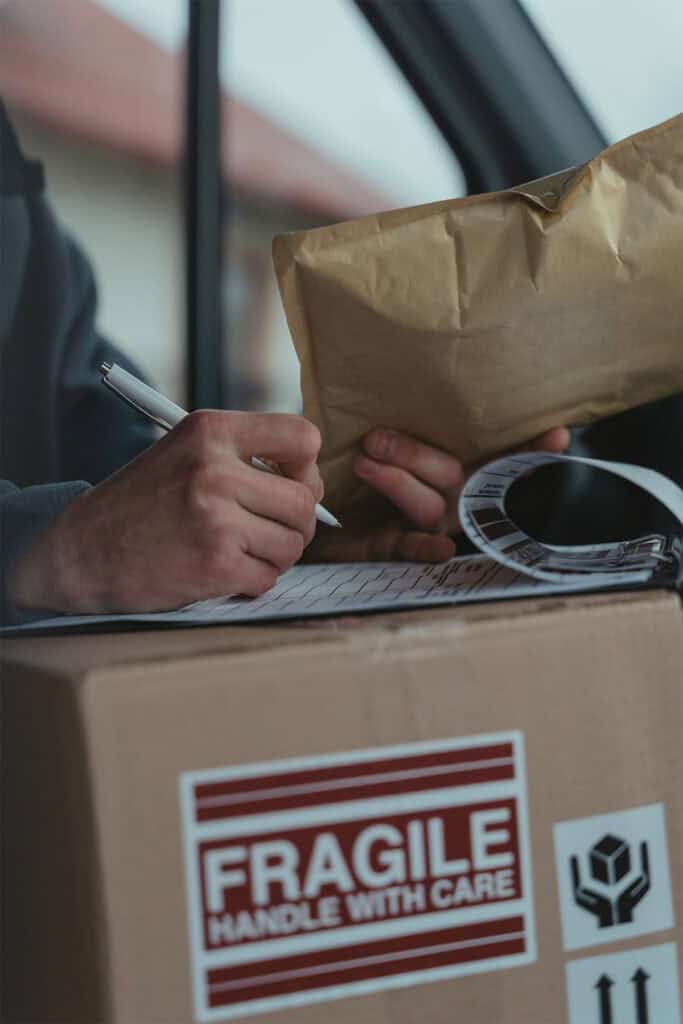 person writing on a piece of paper on a clipboard.