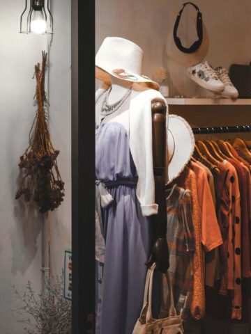 a picture of a buy-sell-trade store with a mannequin and a clothing rack.