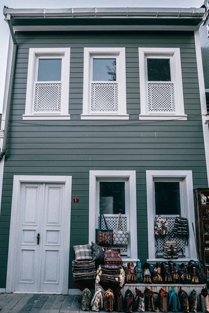 a house with purses and blankets outside.