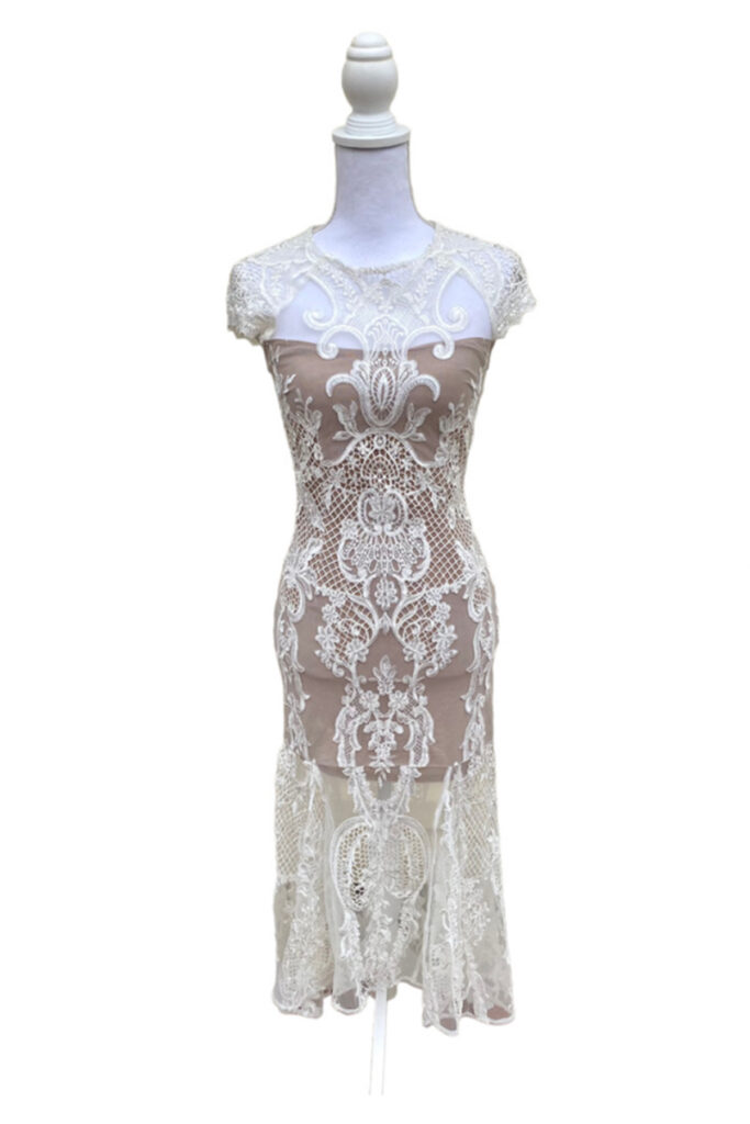 a white lace dress on a mannequin.