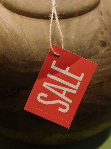 a close up of a lamp with a red sale tag tied around it.