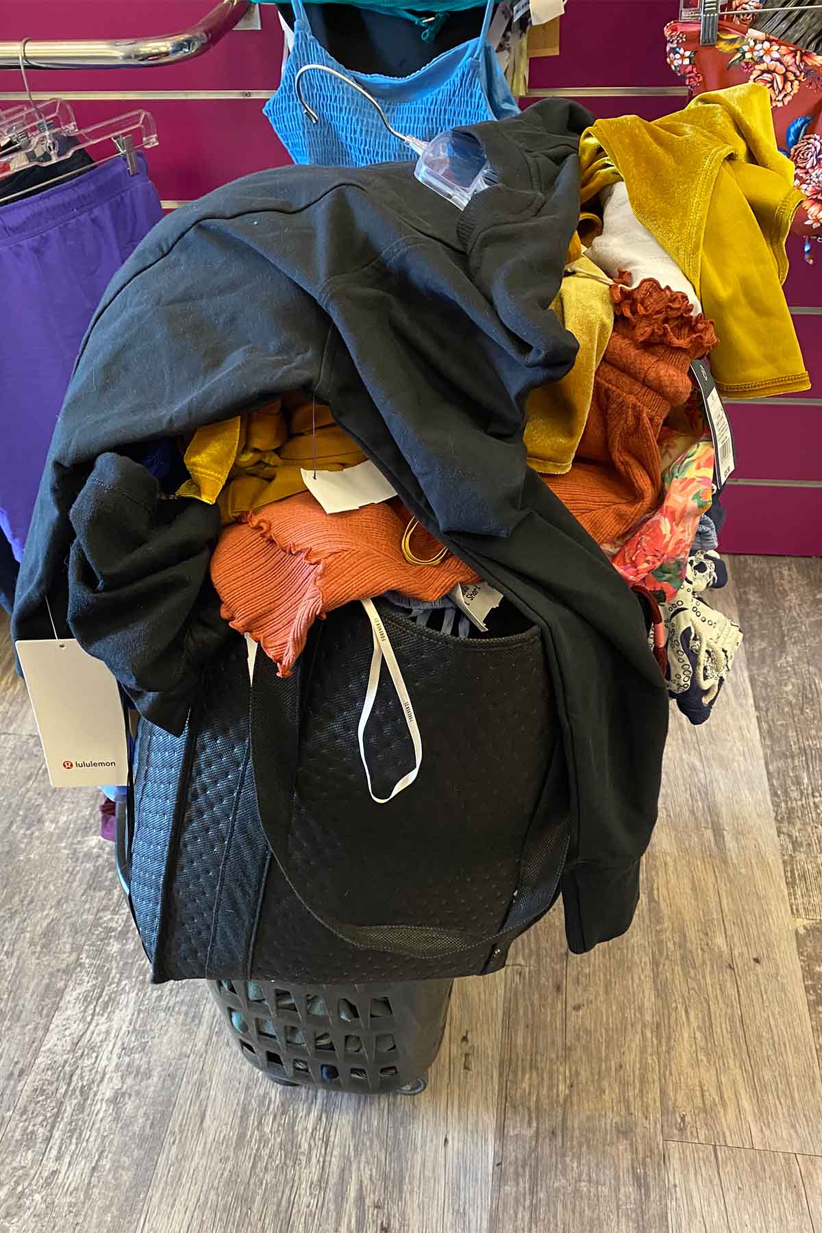 a pile of clothes in a black cart.