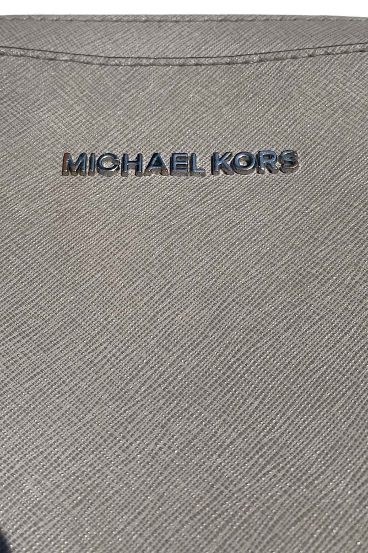 close up of the front of a michael kors purse.