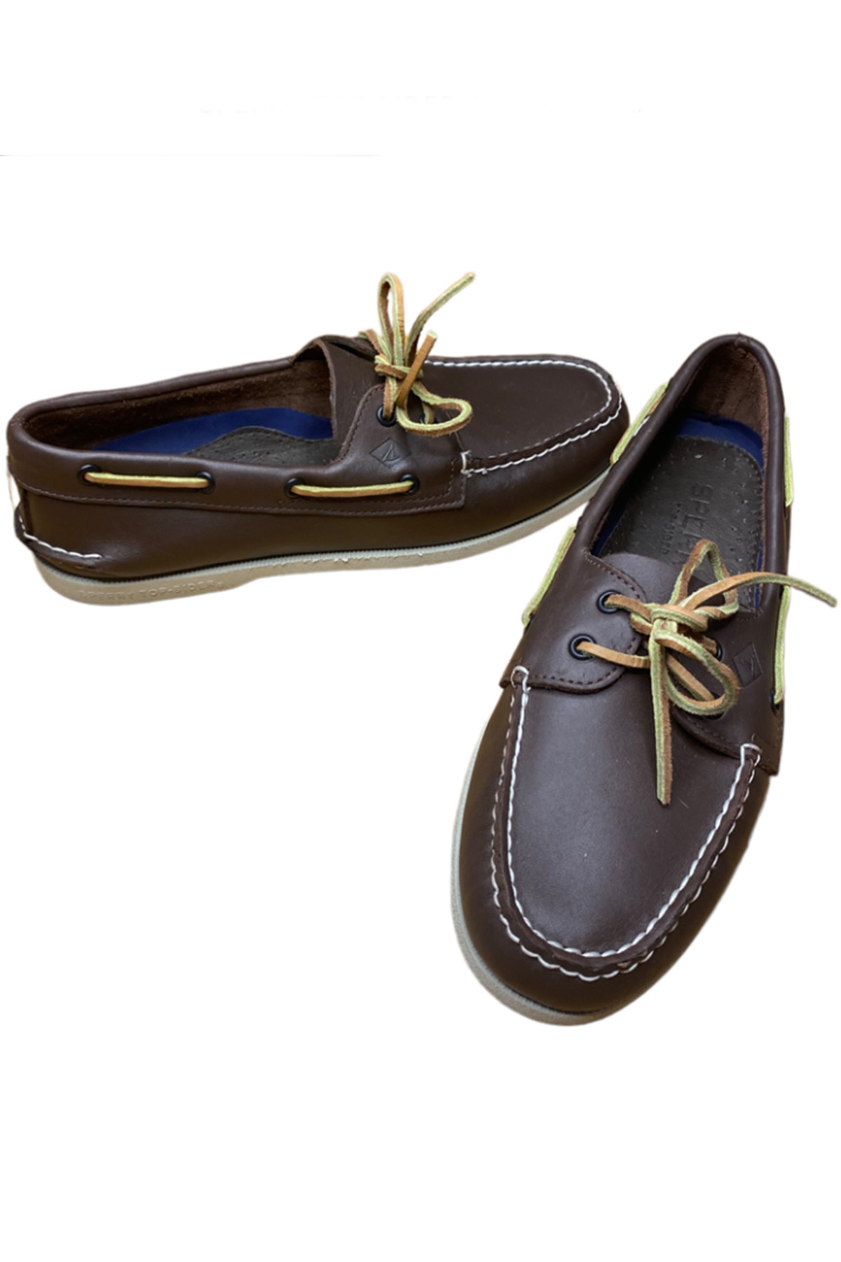 a pair of brown sperry boat shoes.