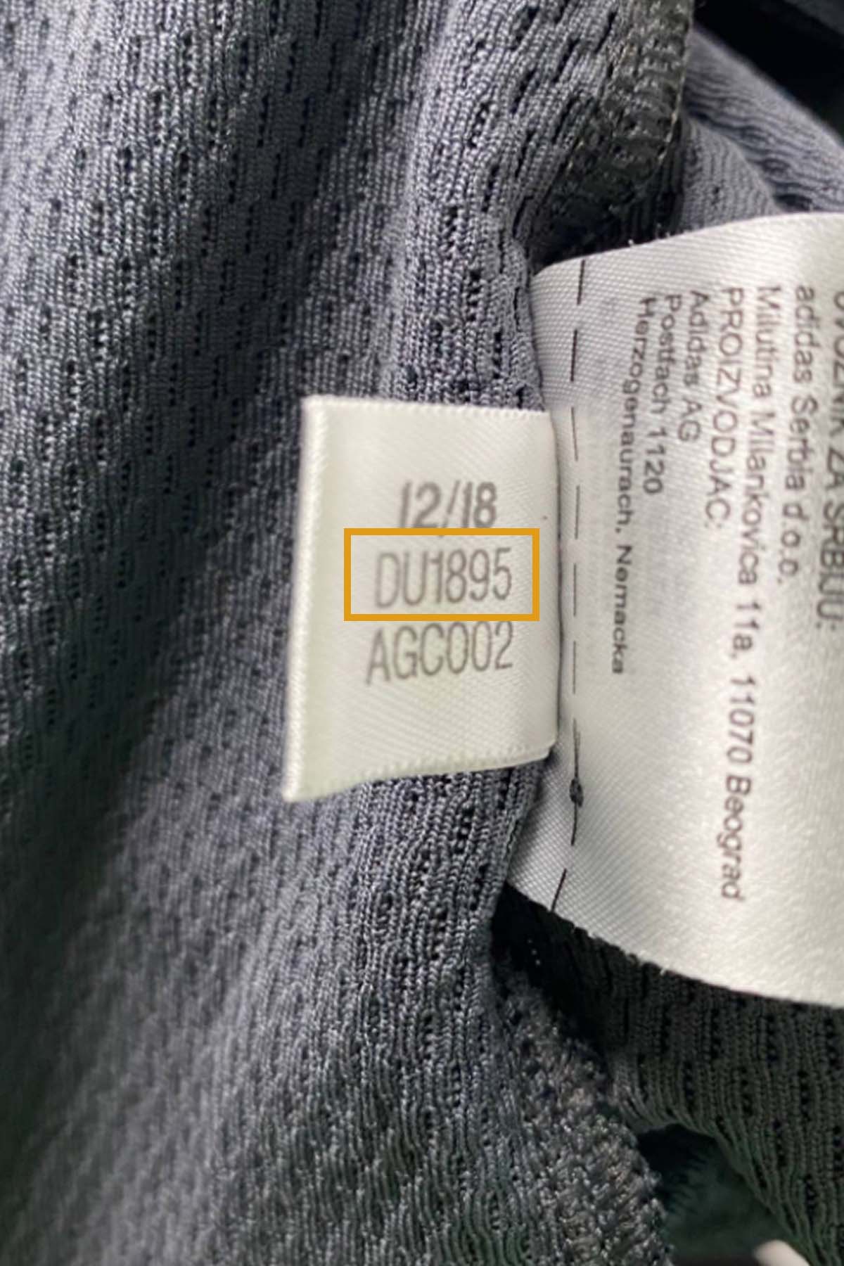 close up of an adidas dress style number tag.