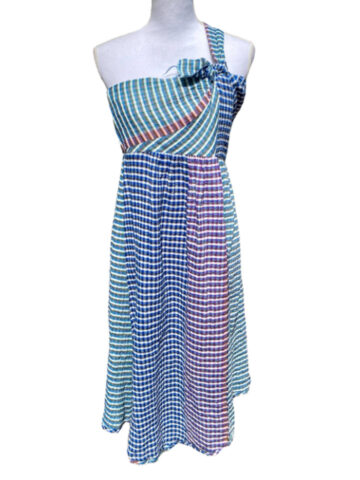 a blue, green, and red plaid dress on a white mannequin.