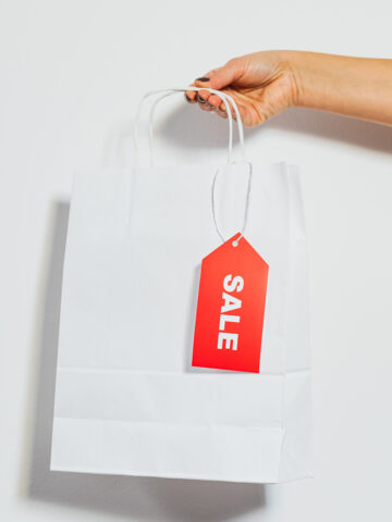 a white bag with a red tag that says sale on it.