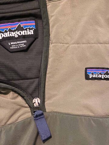 close up of a patagonia brand symbol on a zip jacket.