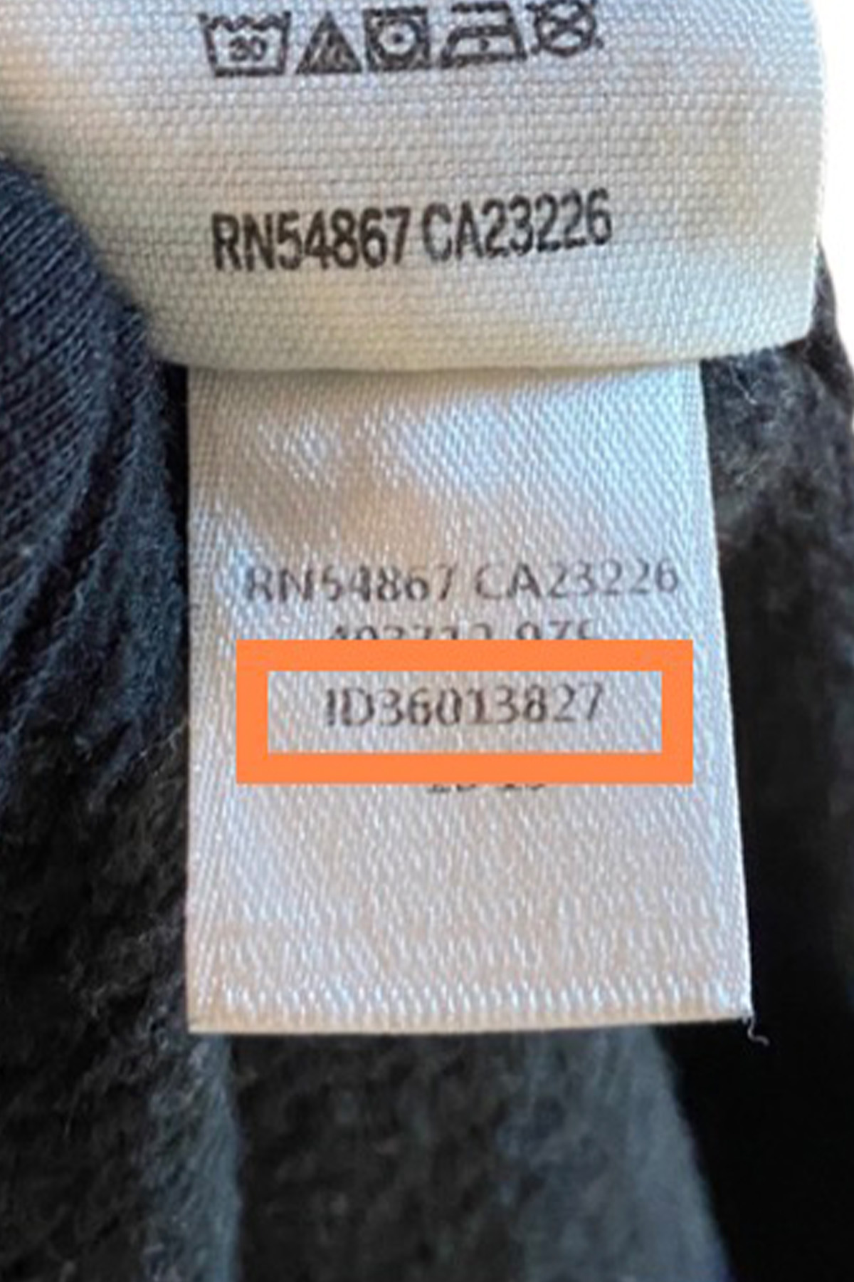 an item number tag on a black victoria's secret hoodie.