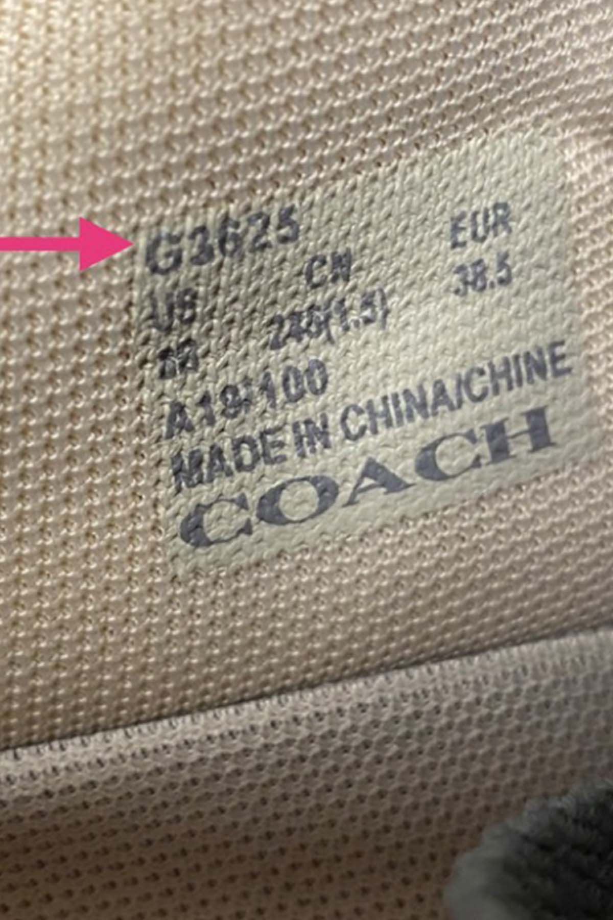 up close picture of the inside of a pair of coach shoes with an arrow pointing to the coach style number.